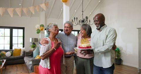 Happy Senior Friends Celebrating Birthday with Cake