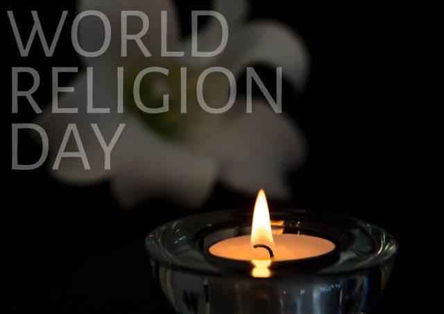 Picture of a lit candle in a dark setting with 'World Religion Day' text in background. White flower visible. Idea for illustrating themes of harmony and spirituality. Use in articles, social media posts, event promotions, and educational materials related to religious diversity and unity.