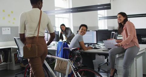 Diverse colleagues enjoying workplace interaction