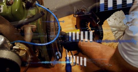 Mechanic repairing engine, gloved hand turning bolt on workbench with digital overlays