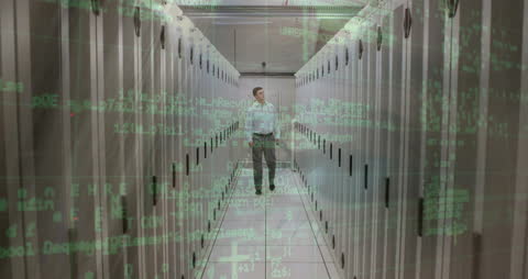 Male IT Technician Walking Through Data Center