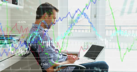 Man Analyzing Financial Data with Laptop in Bright Office