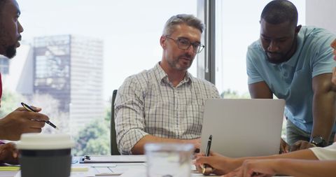 Diverse Professionals Collaborating in Modern Office on a Laptop - Download Free Stock Images Pikwizard.com