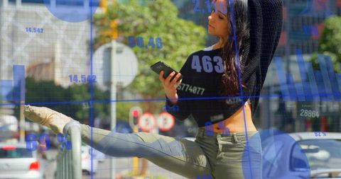 Urban fitness woman stretching on railing while checking phone with blue data overlay