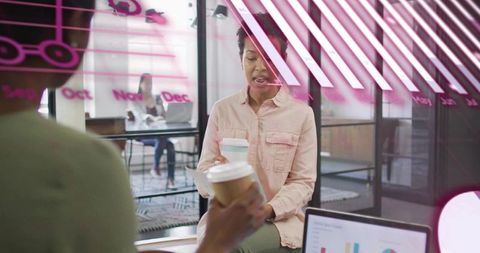 Holding To-Go Cup During Coworking Discussion With Laptop Charts and Pink Glass Decals