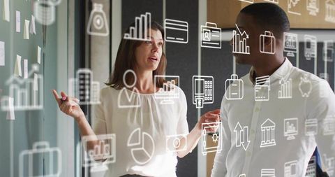 Business team collaborating at glass board with data icons and charts for planning