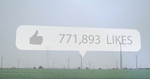 Floating social likes bubble hovering above windfarm landscape conveying renewable energy