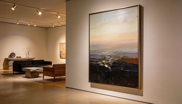 Large abstract landscape painting hanging in minimalist gallery with warm ambient lighting