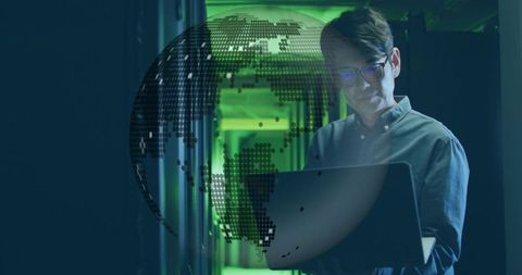 IT Technician Analyzing Data with Digital Globe Overlay