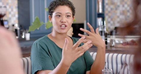 Woman Engaging in Animated Discussion with Friends at Home