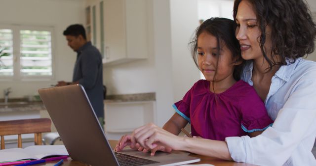 Mother and Daughter Using Laptop in Home Kitchen - Download Free Stock Images Pikwizard.com