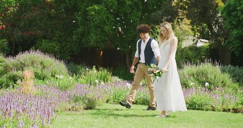 Joyful Couple Walking in Garden at their Wedding Day - Download Free Stock Images Pikwizard.com
