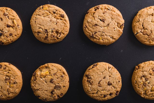 Perfect for use in food blogs, recipe websites, or advertisements for bakeries and cafes. The image showcases a neat arrangement of chocolate chip cookies, making it ideal for promoting homemade baking or dessert recipes.
