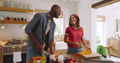 Couple Preparing Vegetables Together in Rustic Farmhouse Kitchen