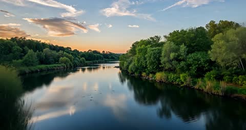 Dusk Reflections on a Tranquil River in Lush Forest Landscape