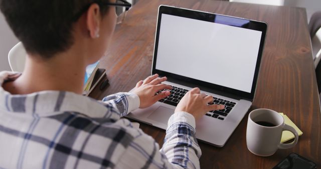 Person working on laptop with coffee on desk - Download Free Stock Images Pikwizard.com