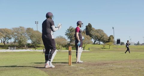Cricket Players Ready to Bat on Sunny Day