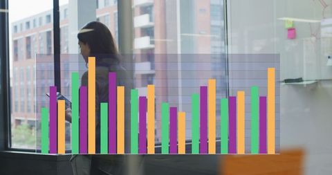 Woman analyzing growth charts in modern office interior