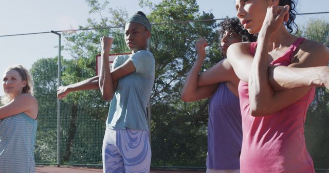 Diverse Female Athletes Stretching on Sunny Basketball Court - Download Free Stock Images Pikwizard.com