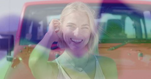 Smiling Woman Standing in Front of Red SUV in Sunny Parking Lot
