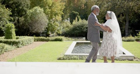 Joyful Senior Couple Dances at Garden Wedding Ceremony - Download Free Stock Images Pikwizard.com