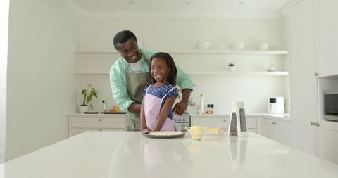 Father and Daughter Cooking Together Bonding in Modern Kitchen