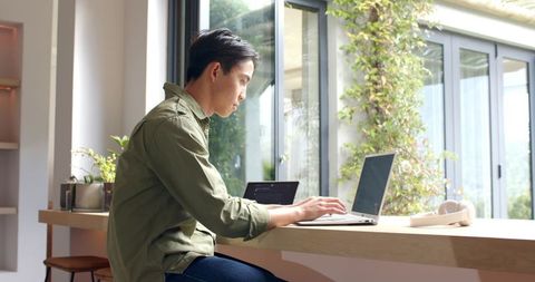 Man Working Remotely at Modern Home Office Desk