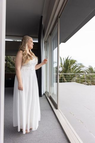 Elegant woman in lace dress enjoying suite view
