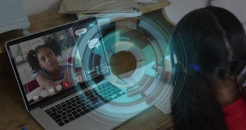 Two schoolgirls participating in remote learning with holographic hud overlay on laptop