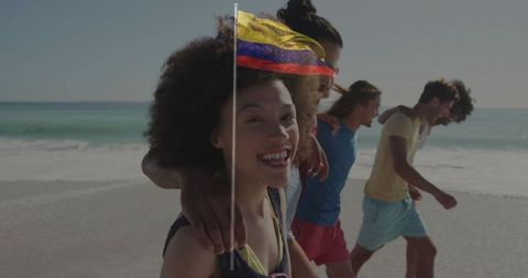 Friends Walking on Beach Holding Venezuelan Flag