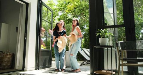Excited Female Friends Arriving Forging New Memories at Vacation Getaway