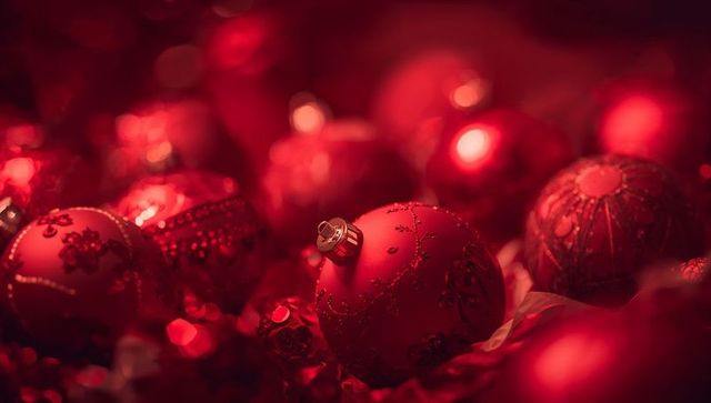Shimmering red christmas baubles creating warm festive bokeh and glittering ornaments