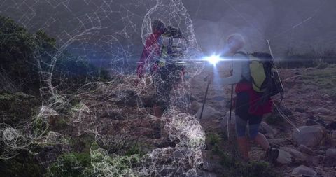 Couple Trekking Rocky Mountain Trail with Backpacks and Hiking Poles