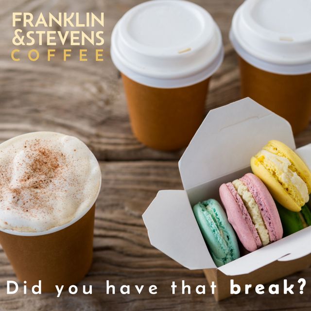 Perfect for promoting cafes, coffee shops, and bakeries, this image shows takeaway coffee cups and pastel-colored macarons on a rustic wooden table. It conveys a cozy, inviting atmosphere ideal for marketing campaigns focused on relaxation, breaks, or casual dining.