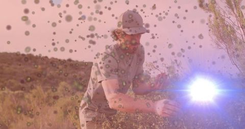 Adventurous male explorer studying nature amid lens flare effects