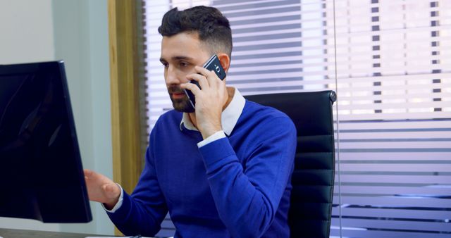 Young Businessman Discussing on Mobile Phone in Modern Office - Download Free Stock Images Pikwizard.com