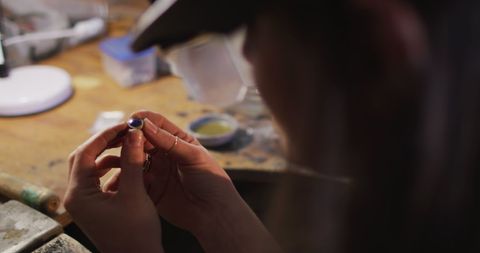 Focused Jeweler Inspecting Precision in Handmade Jewelry Craft