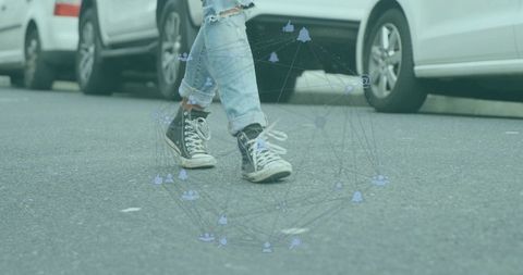 Walking in rolled ripped jeans with scuffed black high-tops and social network overlay