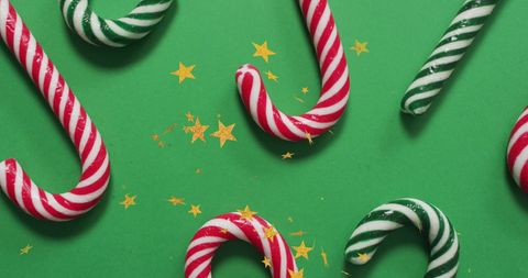 Festive Candy Canes and Stars on Green Background