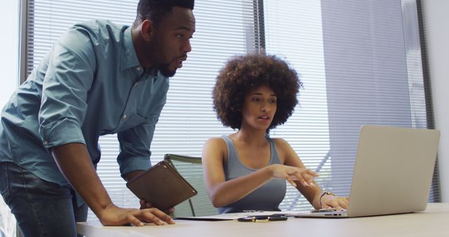 Young African American colleagues collaborating on project in modern office - Download Free Stock Images Pikwizard.com