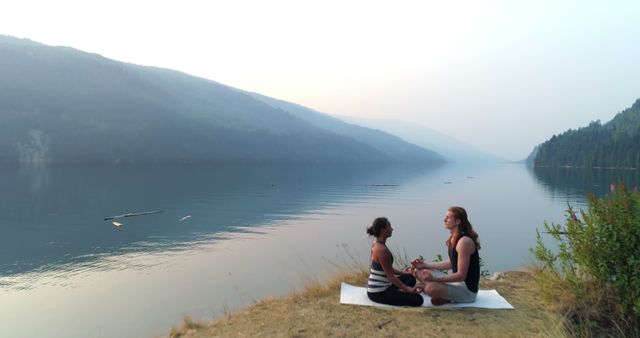 Couple Meditating by a Tranquil Lake at Dusk - Download Free Stock Images Pikwizard.com