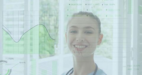 Smiling female clinician presenting green healthcare data overlay in bright clinic