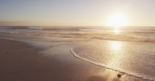 Serene Sunset Over Calm Ocean Waves at Sandy Beach - Download Free Stock Photos Pikwizard.com