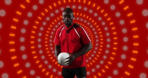 American Football Player Holding Ball with Dynamic Background