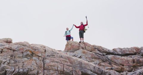 Senior Hiker Couple Celebrating Summit on Rocky Adventure