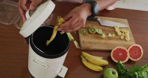 Hands composting kitchen waste for eco-friendly living