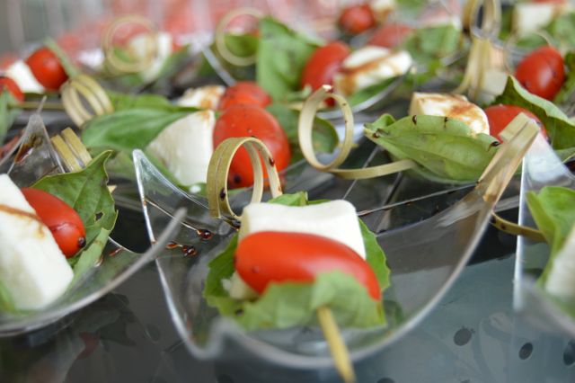 Caprese salad skewers consisting of fresh mozzarella, cherry tomatoes, and basil leaves arranged artfully with drizzles of balsamic glaze and stylish bamboo toothpicks. Ideal for use in catering services, party invitations, gourmet recipe blogs, and elegant dining articles. Reflecting freshness, sophistication, and tasty appetizers suitable for upscale events and social gatherings.