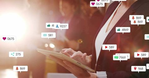 Businesswoman tapping tablet at conference with floating social media alerts and metrics