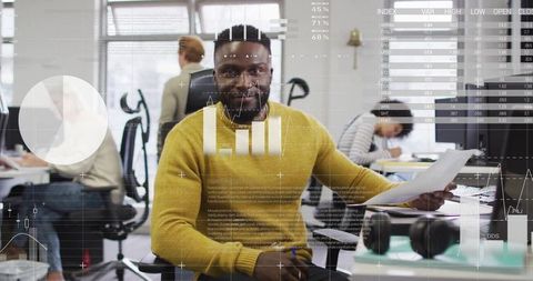 Business Analyst Reviewing Data in Modern Office Environment