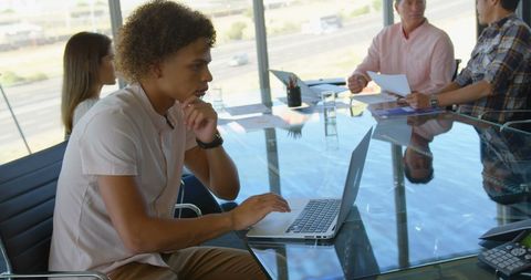Focused Young Professional Working On Laptop